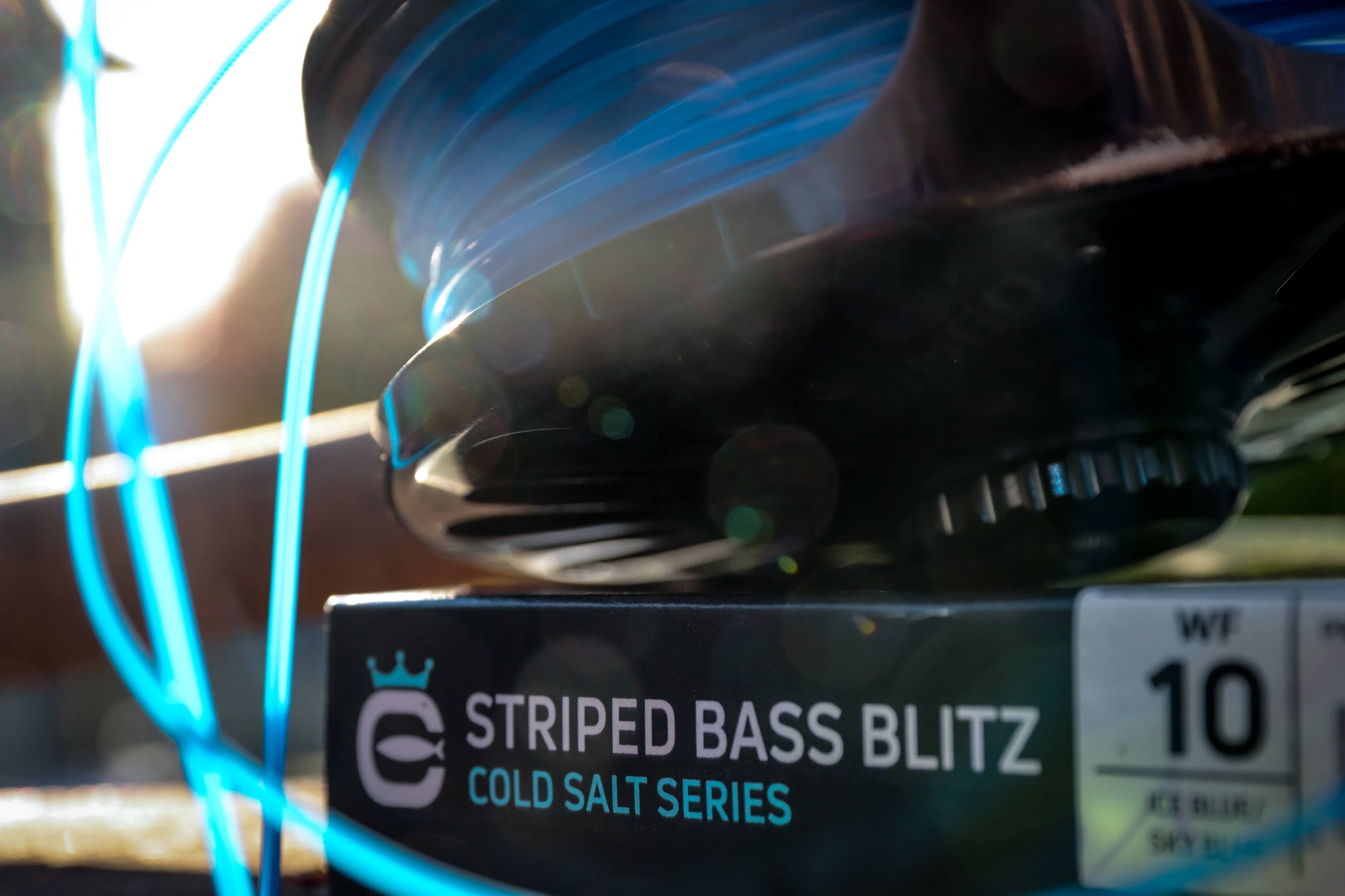 Striped Bass Blitz Box with a fly reel sitting on top of it