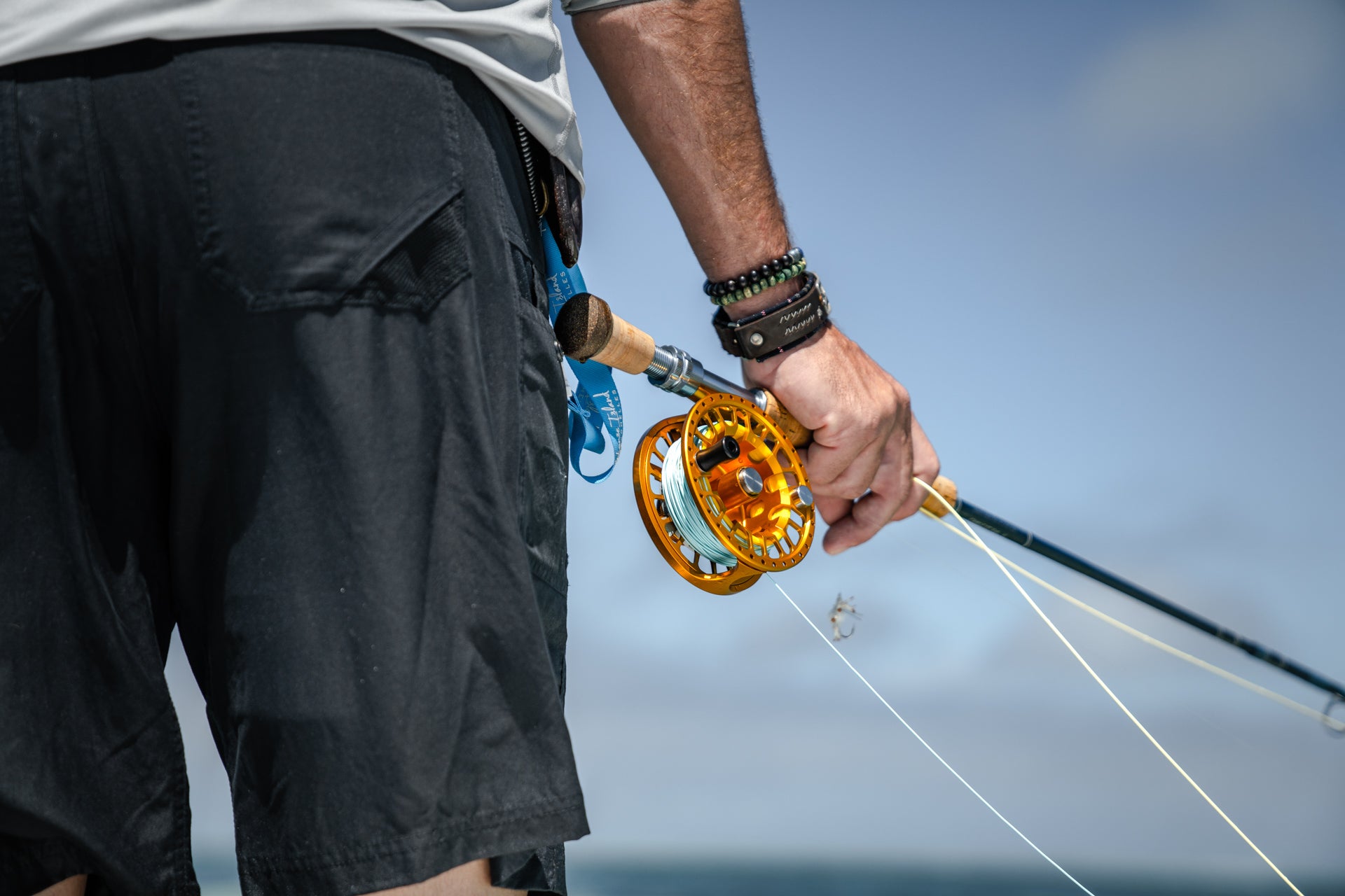 Someone holding onto their rod and reel.