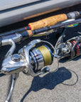 Closeup shot of two fishing poles. The pole in view is lined with Cortland Master Braid Bronze. 