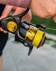 Closeup shot of a fishing reel that is lined with Cortland Master Braid - Yellow. 